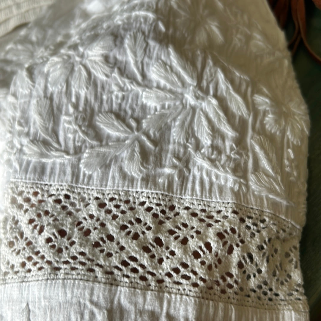 Close up on white chikan work on pants